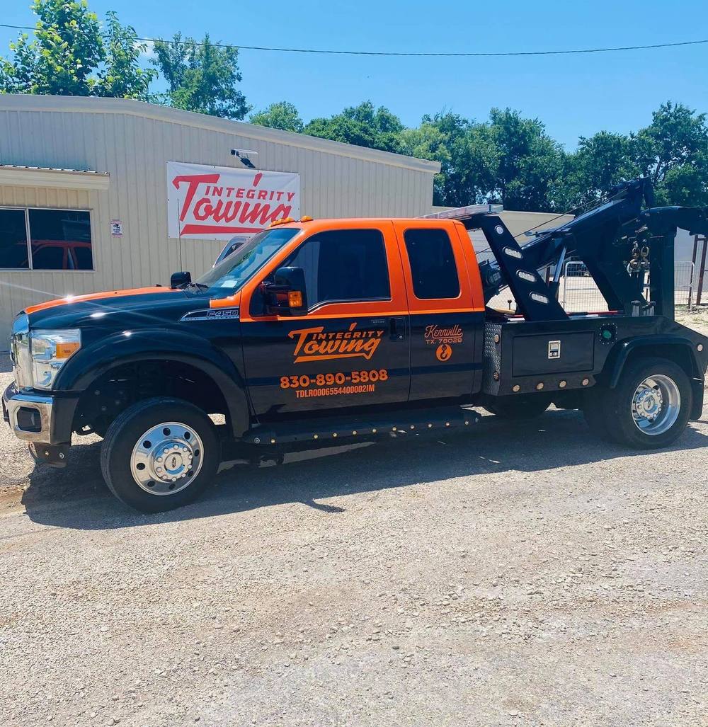 An Integrity Towing truck parked outside the shop in Kerrville, TX